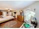 Cozy main bedroom with wood floors, ceiling fan, a mounted TV, and backyard access at 1011 Dampierre Ct, Kissimmee, FL 34759
