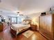 This cozy main bedroom offers a plush bed, wooden flooring and drawers, and a ceiling fan at 1011 Dampierre Ct, Kissimmee, FL 34759