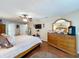 Charming main bedroom featuring wood floors, ceiling fan, a mounted TV, and a vanity at 1011 Dampierre Ct, Kissimmee, FL 34759