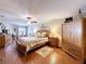 This cozy main bedroom offers a plush bed, wooden flooring and drawers, and a ceiling fan at 1011 Dampierre Ct, Kissimmee, FL 34759