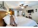 Fully furnished main bedroom with a mounted television, multiple windows, and private bathroom access at 1011 Dampierre Ct, Kissimmee, FL 34759