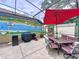 Outdoor dining area on the patio with a grill and mural painted on the home at 1011 Dampierre Ct, Kissimmee, FL 34759
