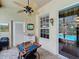 Cozy patio featuring an outdoor window, a fan, a work station, and views of the pool area at 1011 Dampierre Ct, Kissimmee, FL 34759