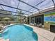 Lovely pool area with screened enclosure, patio furniture, and unique mural design at 1011 Dampierre Ct, Kissimmee, FL 34759