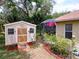 Backyard shed with garden area and screened-in porch at 1011 Dampierre Ct, Kissimmee, FL 34759