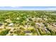 An aerial view shows a residential area with lush greenery and mature trees at 1024 Cohassett Ave, Lake Wales, FL 33853