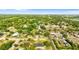 A sprawling residential area is surrounded by mature trees and lush greenery at 1024 Cohassett Ave, Lake Wales, FL 33853