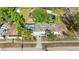An aerial view shows a well-maintained property with a screened-in pool and mature landscaping at 1024 Cohassett Ave, Lake Wales, FL 33853