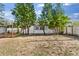 Expansive backyard featuring young trees, partial fencing, and a natural landscape at 1024 Cohassett Ave, Lake Wales, FL 33853