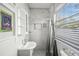 Contemporary bathroom with marble-like tile, a sleek vanity, and a window offering natural light and privacy at 1024 Cohassett Ave, Lake Wales, FL 33853