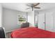 Bedroom featuring a ceiling fan, hardwood floors, a window, and a dresser at 1024 Cohassett Ave, Lake Wales, FL 33853