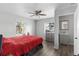 Bedroom featuring a ceiling fan, hardwood floors, two windows, and a connected bathroom at 1024 Cohassett Ave, Lake Wales, FL 33853