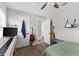 Bedroom features musical instruments, an open doorway, and hardwood flooring at 1024 Cohassett Ave, Lake Wales, FL 33853