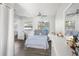 Serene bedroom with plush blue bedding, ample natural light, and neutral decor for a tranquil retreat at 1024 Cohassett Ave, Lake Wales, FL 33853