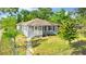 A cozy home features a small porch with a sidewalk and a few trees at 1024 Cohassett Ave, Lake Wales, FL 33853