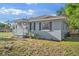 Exterior view of a home with gray siding, black shutters, and a cozy front porch at 1024 Cohassett Ave, Lake Wales, FL 33853