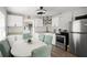 Modern kitchen with stainless steel appliances, tile backsplash, and dining table at 1024 Cohassett Ave, Lake Wales, FL 33853