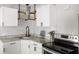 Updated kitchen featuring granite countertops, stainless steel appliances, subway tile backsplash, and open shelving at 1024 Cohassett Ave, Lake Wales, FL 33853