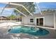This screened-in pool features a lovely design and easy access to the house via sliding glass doors at 1024 Cohassett Ave, Lake Wales, FL 33853