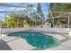 Enjoy the outdoors with a beautiful screened-in pool surrounded by lush landscaping at 1024 Cohassett Ave, Lake Wales, FL 33853