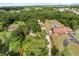 Aerial view of property with sprawling land, mature trees, and nearby pool at 1055 N Chickasaw Trl, Orlando, FL 32825