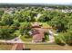 Aerial view showcasing a large property with a well-maintained lawn and mature trees at 1055 N Chickasaw Trl, Orlando, FL 32825