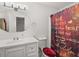 Cozy bathroom featuring a vanity with a framed mirror and a shower with decorative shower curtain at 1055 N Chickasaw Trl, Orlando, FL 32825