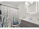 Updated bathroom featuring stylish vanity, decorative mirror, and shower/tub combo with shower curtain at 1055 N Chickasaw Trl, Orlando, FL 32825