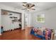 Bright bedroom featuring hardwood floors, ceiling fan, closet, and natural light from a window at 1055 N Chickasaw Trl, Orlando, FL 32825