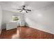 Bedroom featuring hardwood floors, ceiling fan, and natural light from a window at 1055 N Chickasaw Trl, Orlando, FL 32825