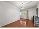 Clean bedroom with hardwood floors, a window letting in natural light, and closet storage at 1055 N Chickasaw Trl, Orlando, FL 32825