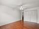 Bedroom with closet featuring hardwood floors, ceiling fan at 1055 N Chickasaw Trl, Orlando, FL 32825