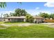 Ranch-style home with a well-maintained lawn and mature landscaping at 1055 N Chickasaw Trl, Orlando, FL 32825