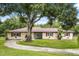 Charming ranch-style home featuring a lovely lawn and mature trees providing ample shade and curb appeal at 1055 N Chickasaw Trl, Orlando, FL 32825