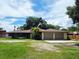Charming single-story home with a two-car garage and inviting curb appeal with a well-manicured lawn at 1055 N Chickasaw Trl, Orlando, FL 32825