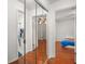 Hallway showing access to the bathroom on the left, and bedroom on the right with mirrored closet at 1055 N Chickasaw Trl, Orlando, FL 32825