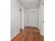 Hallway with wood floors and a large closet with bi-fold doors at 1055 N Chickasaw Trl, Orlando, FL 32825