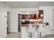 Stylish kitchen featuring dark cabinetry, modern appliances, and a breakfast bar at 1055 N Chickasaw Trl, Orlando, FL 32825
