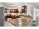 Modern kitchen with stainless steel appliances, granite countertops, and warm wooden cabinets at 1055 N Chickasaw Trl, Orlando, FL 32825