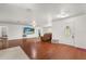 Spacious living room with hardwood floors, white walls, and a decorative front door at 1055 N Chickasaw Trl, Orlando, FL 32825