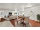 Stylishly furnished living room with hardwood floors, area rug, and dining area at 1055 N Chickasaw Trl, Orlando, FL 32825