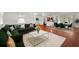 Living room featuring hardwood floors, white rug, green sofa and marble coffee table at 1055 N Chickasaw Trl, Orlando, FL 32825