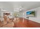 Spacious living room with hardwood floors, a tv, and sliding glass doors to the outdoor patio at 1055 N Chickasaw Trl, Orlando, FL 32825