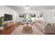 Cozy living room featuring hardwood floors, light colors, and ample natural light at 1055 N Chickasaw Trl, Orlando, FL 32825