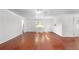 Minimalist living room featuring hardwood floors, white walls and ceiling fan at 1055 N Chickasaw Trl, Orlando, FL 32825