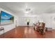 Comfortable living room with hardwood floors, a ceiling fan, and ample natural light at 1055 N Chickasaw Trl, Orlando, FL 32825