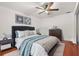 Comfortable main bedroom featuring hardwood floors, ceiling fan, and closet at 1055 N Chickasaw Trl, Orlando, FL 32825
