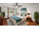 Comfortable main bedroom featuring hardwood floors, ceiling fan, and natural light from a window at 1055 N Chickasaw Trl, Orlando, FL 32825