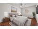 Comfortable main bedroom featuring hardwood floors, ceiling fan, and natural light from a window at 1055 N Chickasaw Trl, Orlando, FL 32825