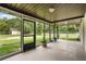 Large screened porch offering serene views of the outdoors and lush greenery at 1055 N Chickasaw Trl, Orlando, FL 32825